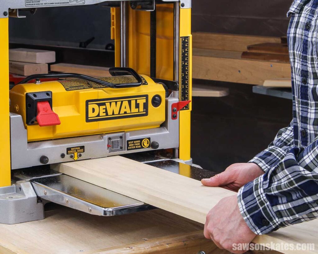 Feeding a board through a planer