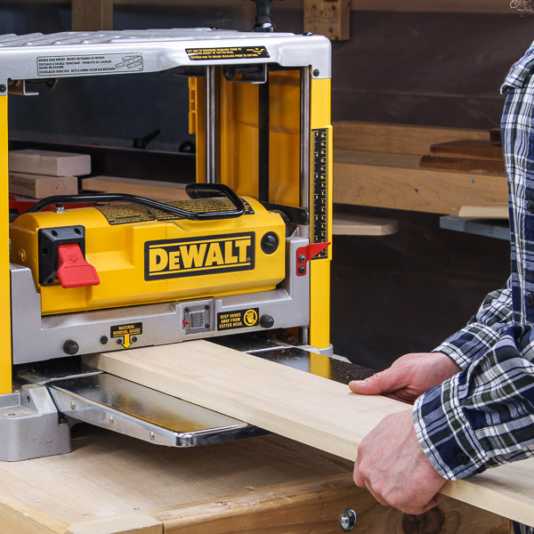Feeding a board through a planer