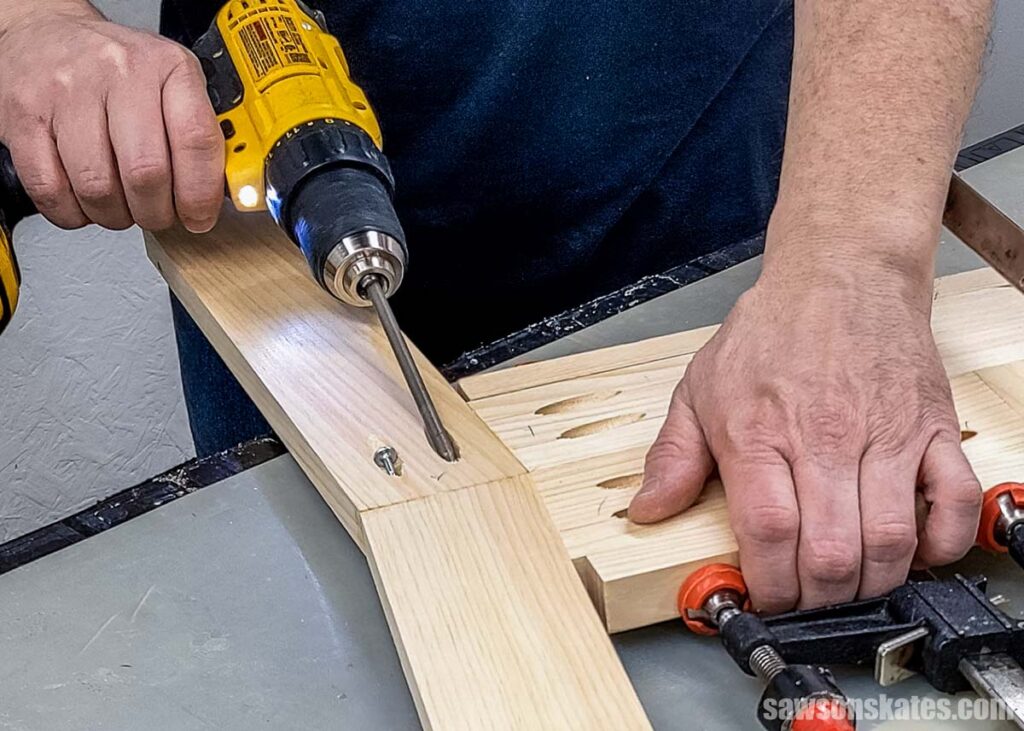 Scott using a drill to drill a pocket hole screw into a pocket hole