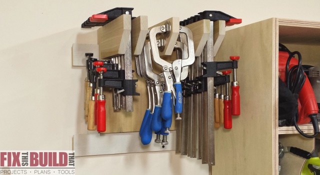 Compact DIY clamp storage rack mounted beside a workshop cabinet for organizing hand screws, locking pliers, and small clamps within easy reach.