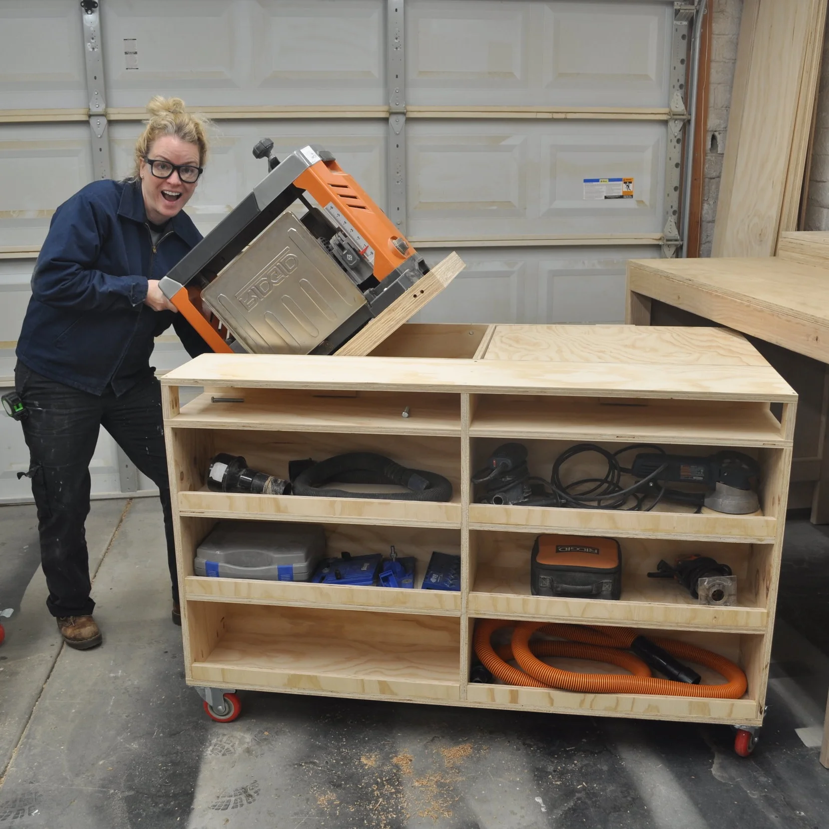 Person flipping a planer in DIY workbench in a garage shop