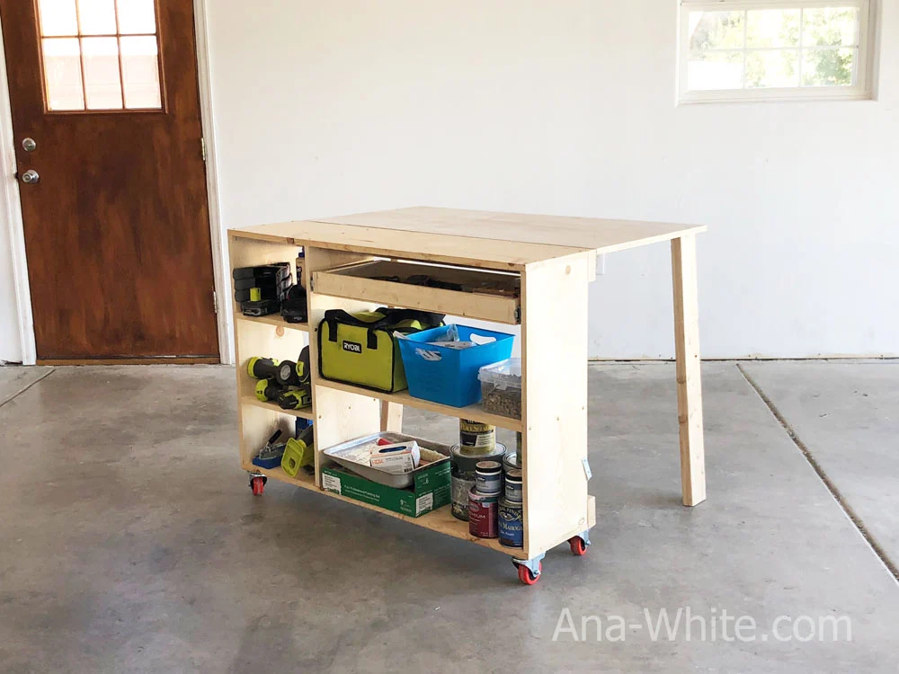 Narrow, folding workbench with shelves filled with tools