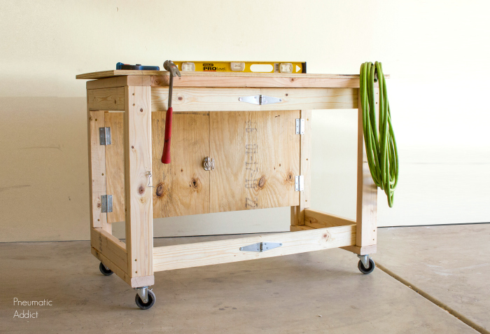 Hinged folding workbench in the open position with tools