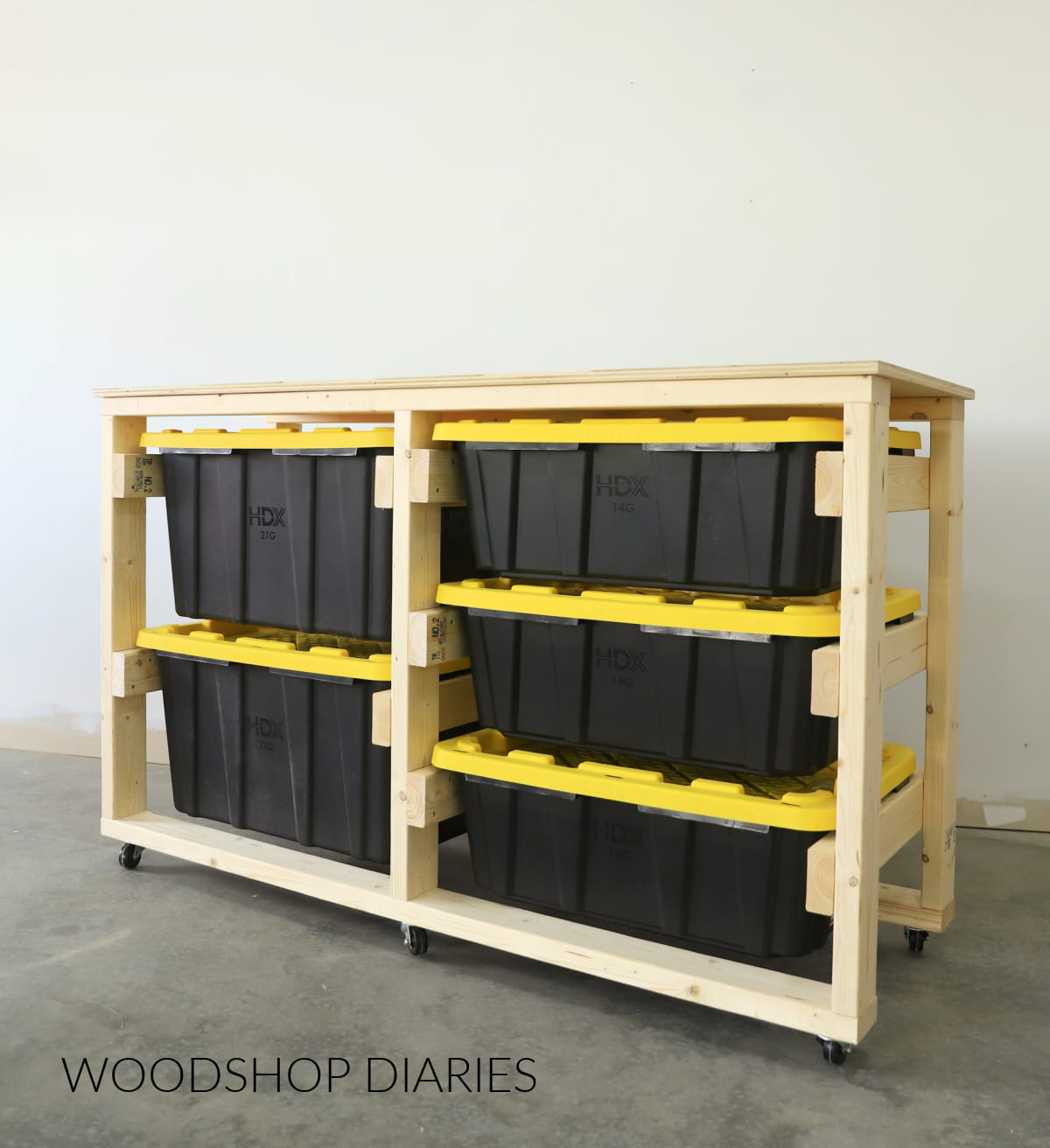 Rolling wooden storage rack holding black plastic totes with yellow lids in a garage.
