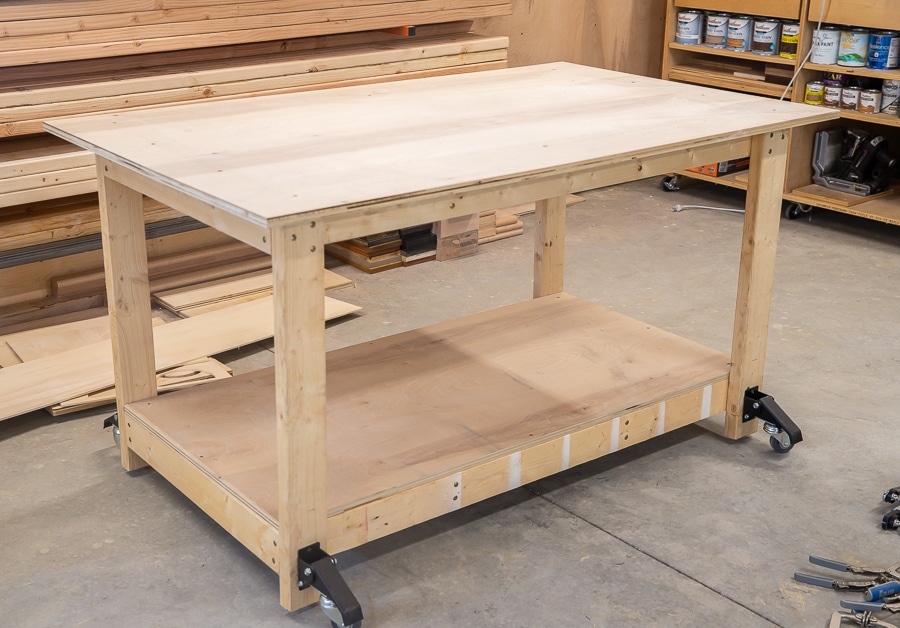 Mobile workbench on a concrete floor in front of lumber storage