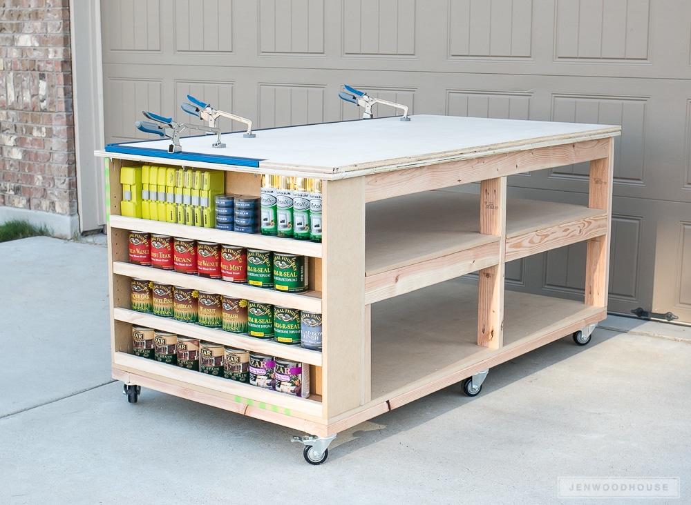 Large rolling workbench with paint storage on the end and two storage shelves beneath the top