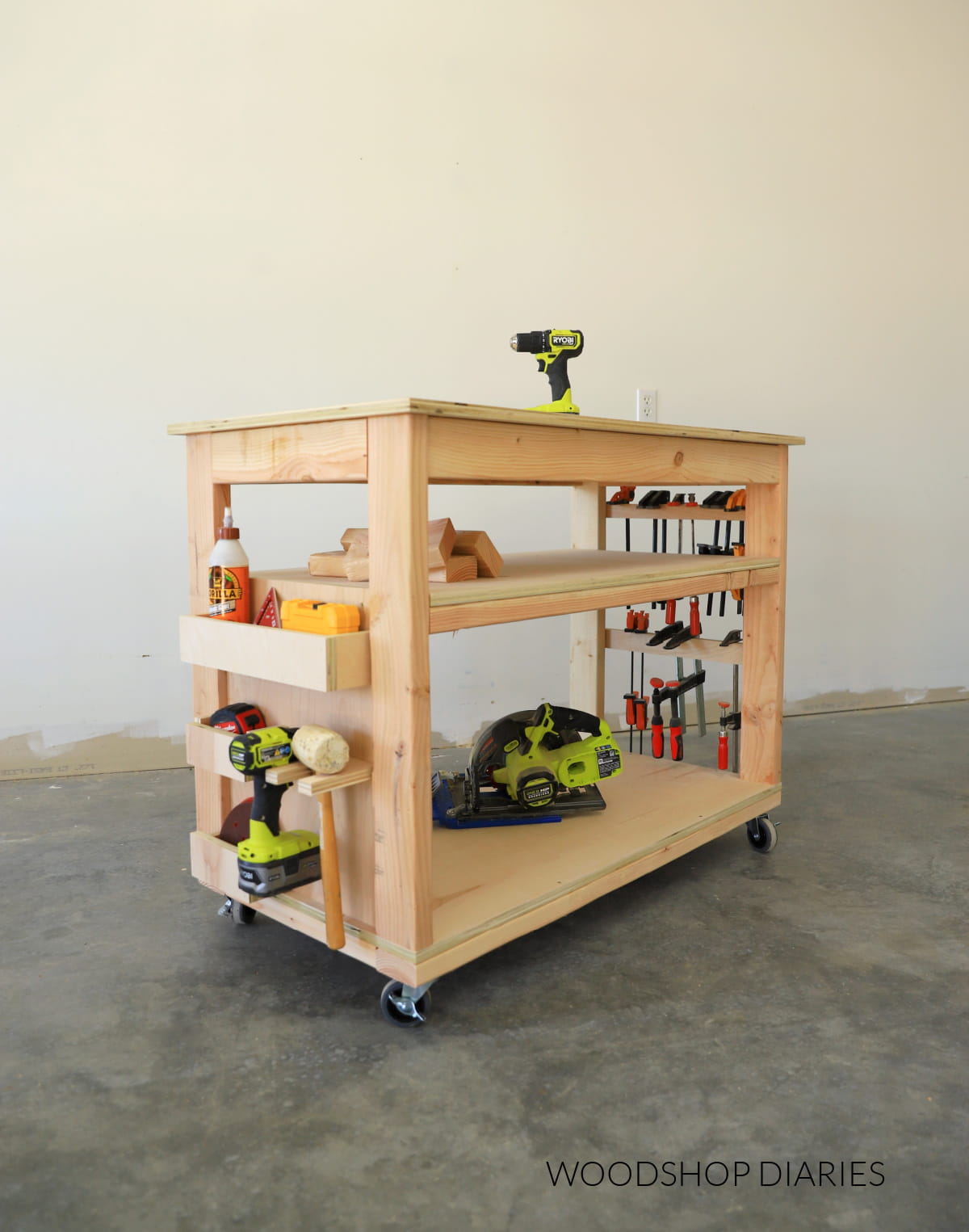Small, rolling workbench with storage shelves and storage on each end
