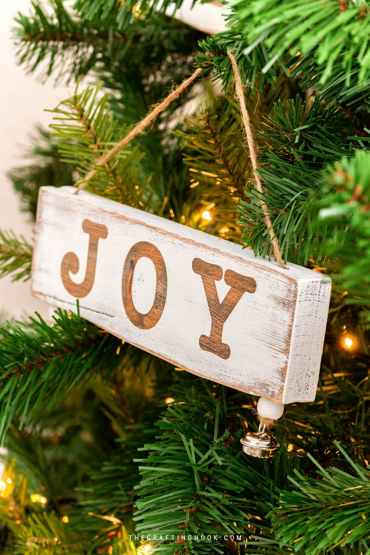 Wood ornament with the word Joy painted on it