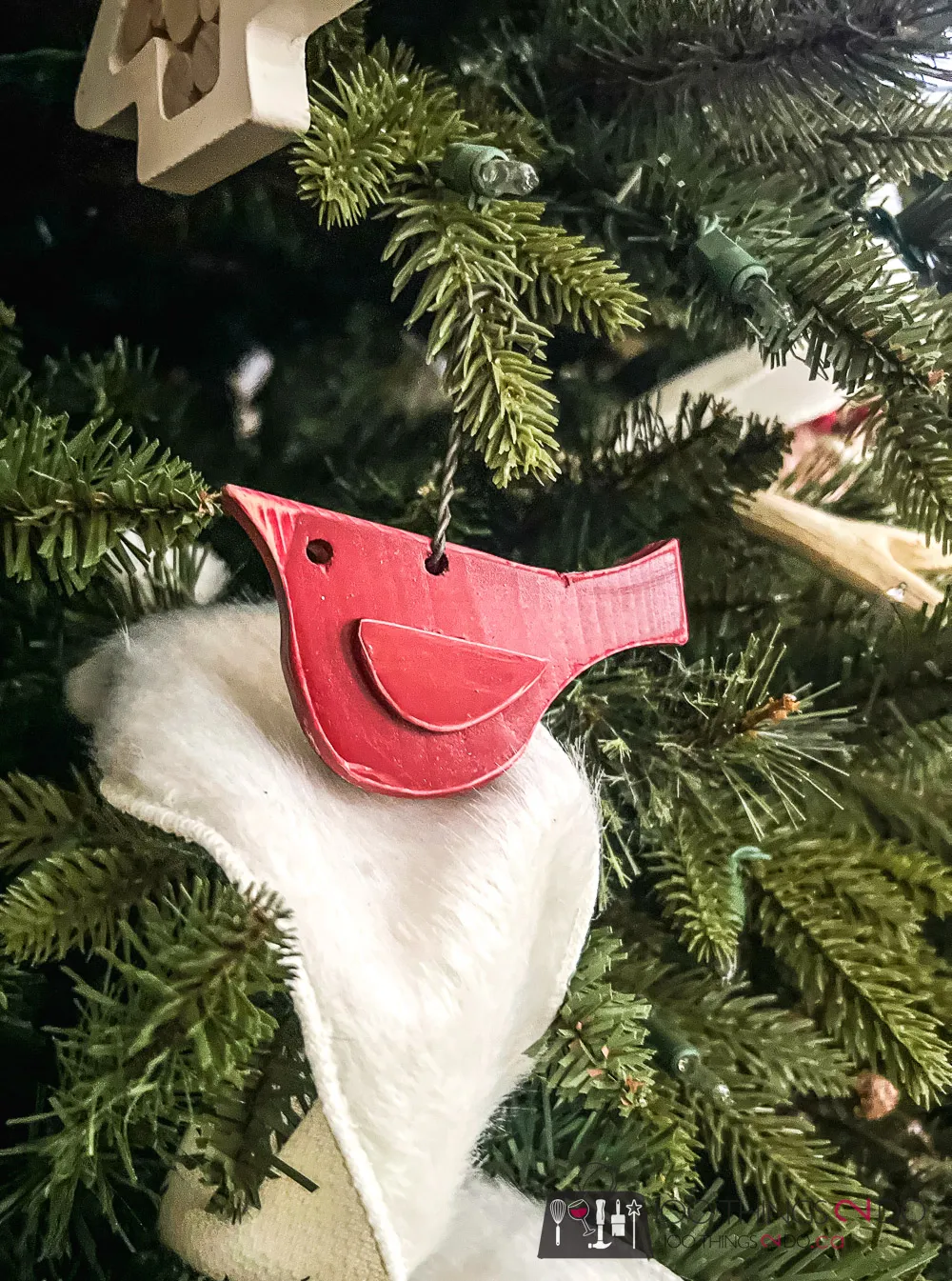 Wood cut in the shape of a cardinal and painted red