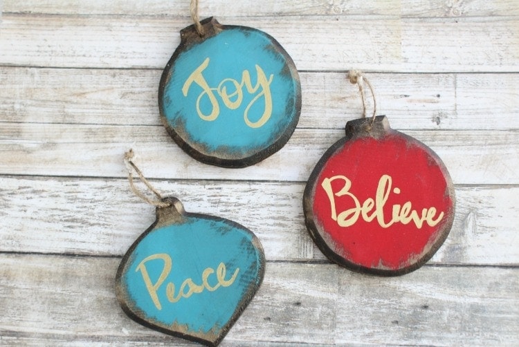 Wood painted ornaments with the words joy, believe and peace