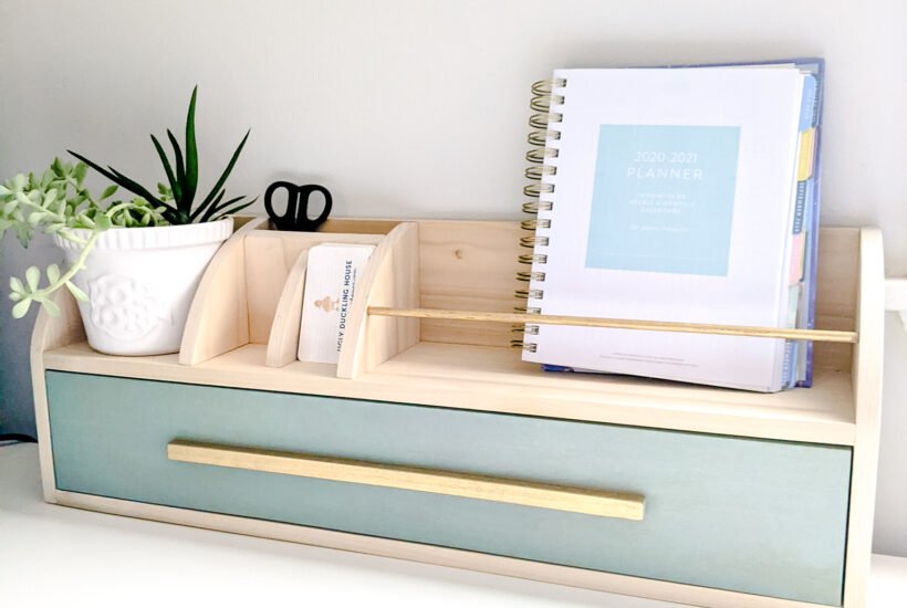 Desk organizer with a lower drawer and cubbies above