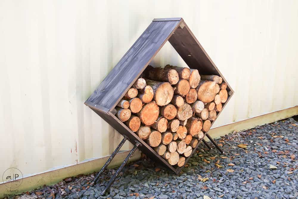 Diamond-shaped firewood holder next to a house