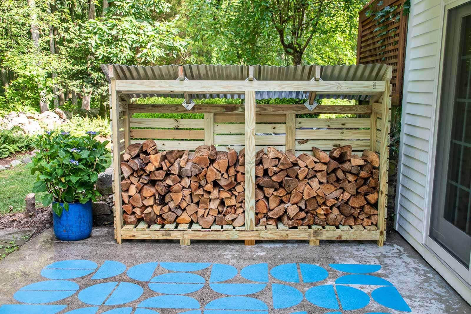 Double-sided firewood shed on a patio