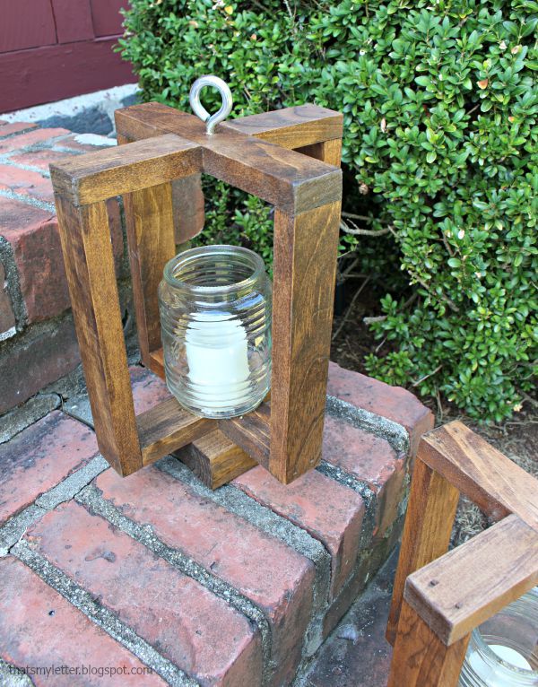 Hanging wood lantern sitting on brick porch step