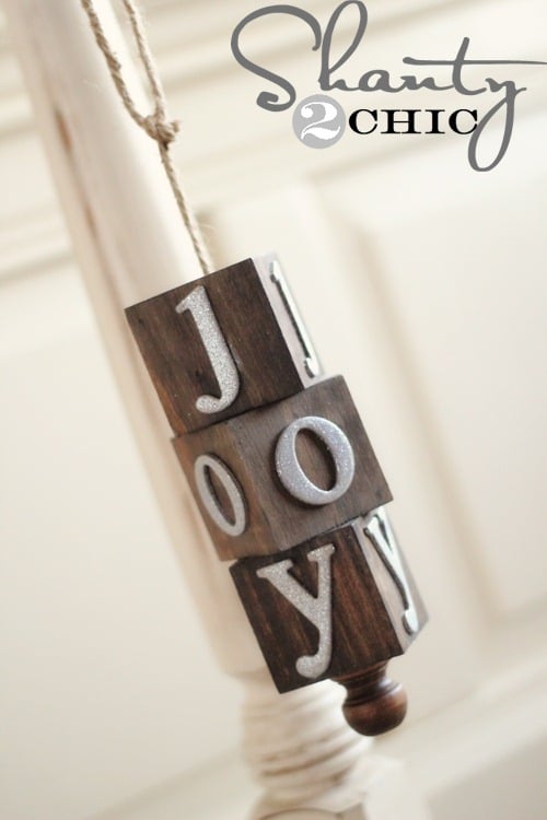 Three wood blocks that spell joy