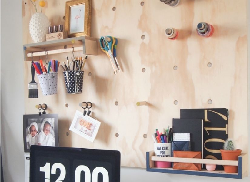 Oversized wooden pegboard with wood pegs and organizational accessories