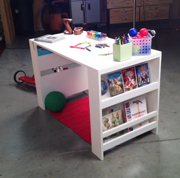 Kid-sized desk with storage on each side and craft supplies on the top