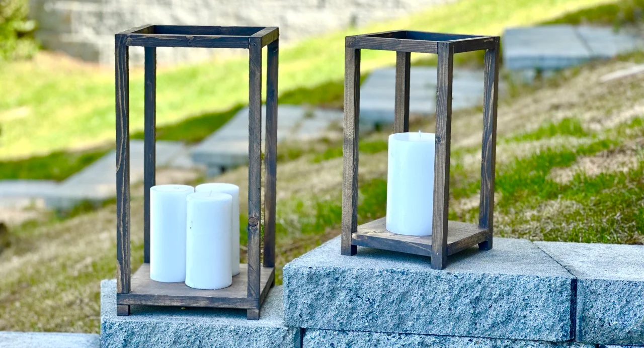 Two wood lanterns on a stone wall