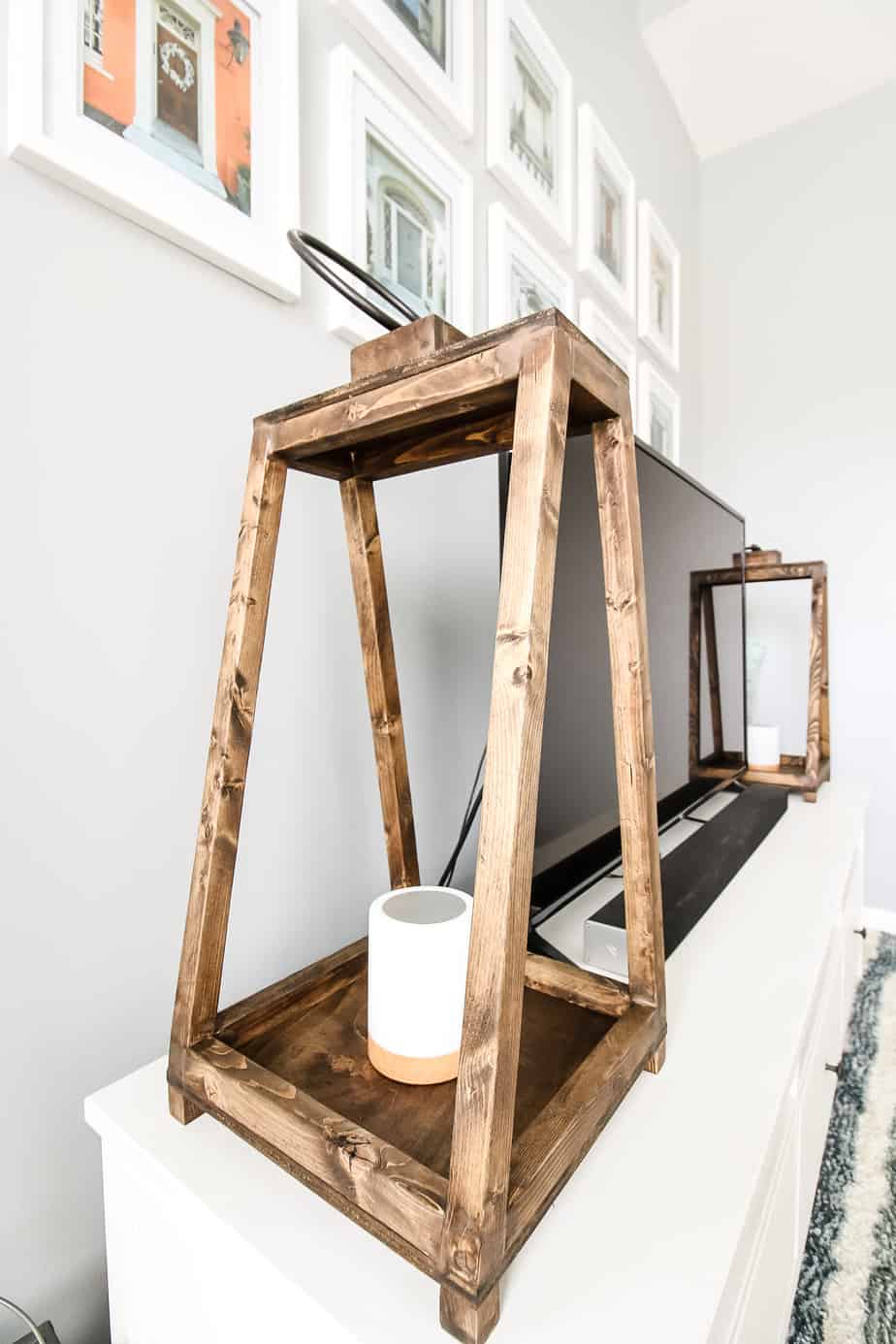 Angled wood lanterns on a tv stand