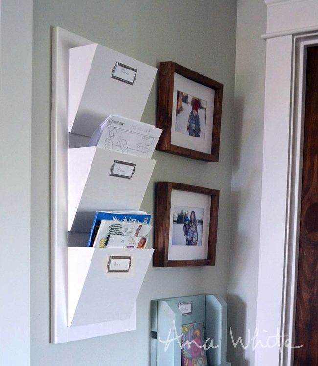 White-painted mail sorter with three bins on a wall