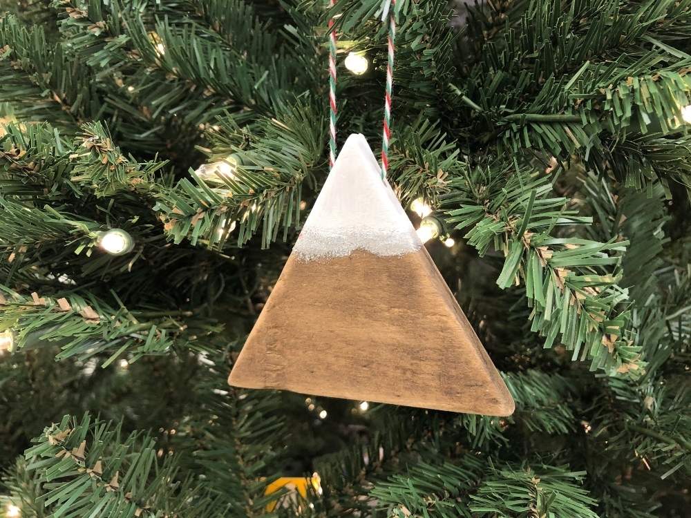 Wood triangle painted to look like a mountain covered in snow