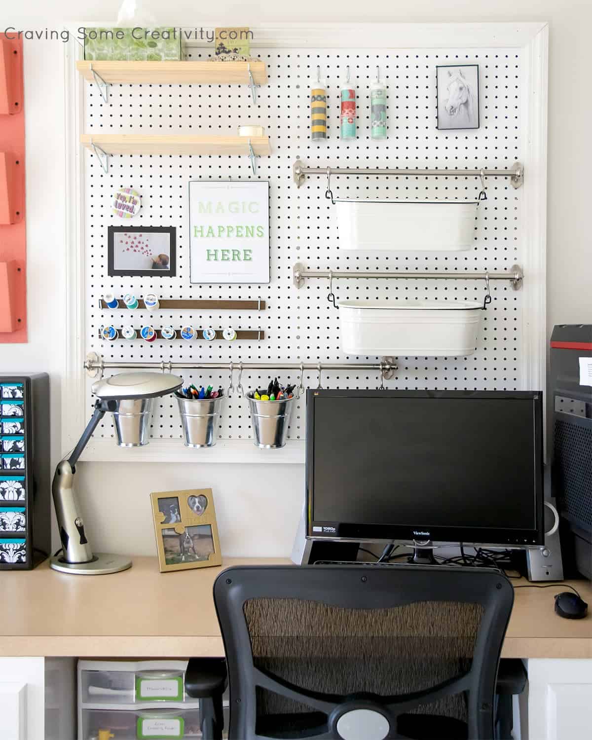 White pegboard framed with trim on the wall behind a desk