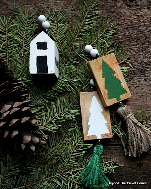Wood blocks painted to look like a house and Christmas trees