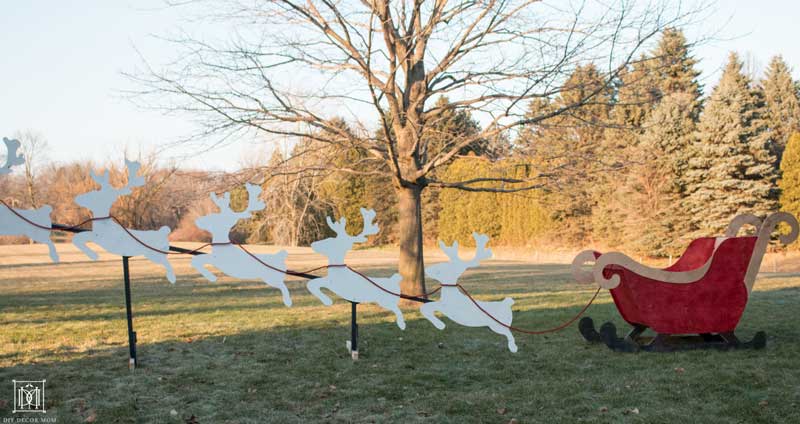 DIY outdoor Christmas sleigh and reindeer in a yard