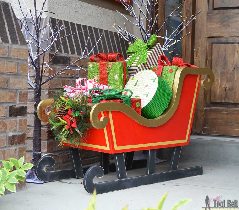 DIY outdoor Christmas sleigh filled with presents