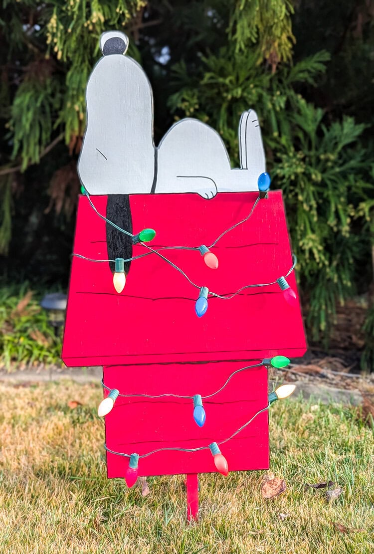 DIY Christmas wood cutout in the shape Snoopy on a doghouse