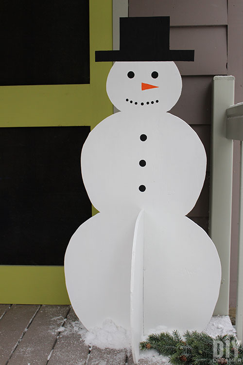 DIY Christmas snowman on a porch next to a door