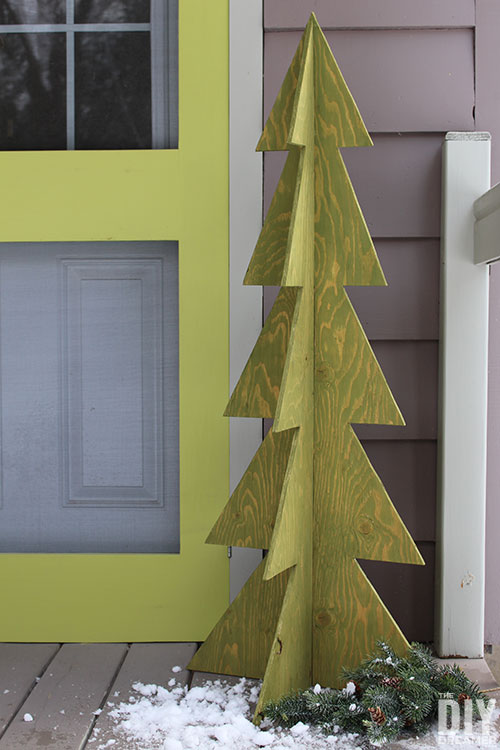 DIY outdoor wood Christmas tree placed next to a front door