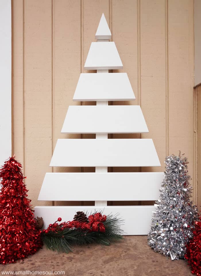 DIY outdoor slated Christmas tree painted white on a porch