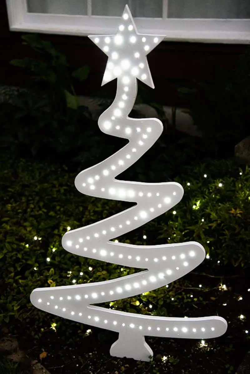 DIY outdoor Christmas tree painted white with white twinkle lights