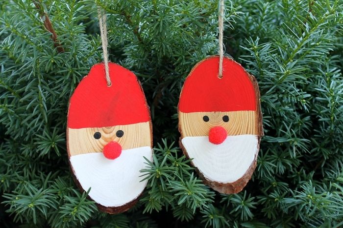 Wood slices painted to look like Santa faces