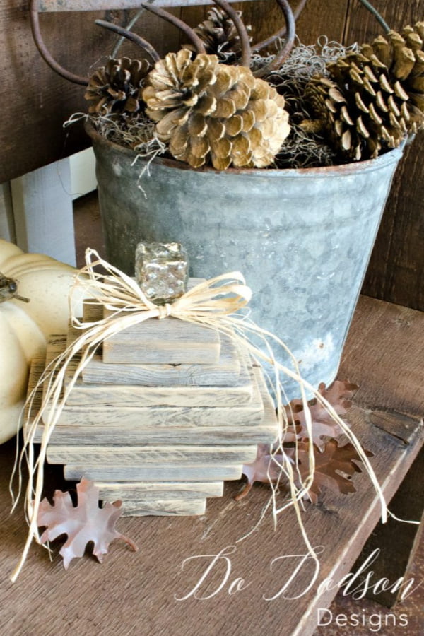 Various lengths of wood stacked vertically to look like a pumpkin