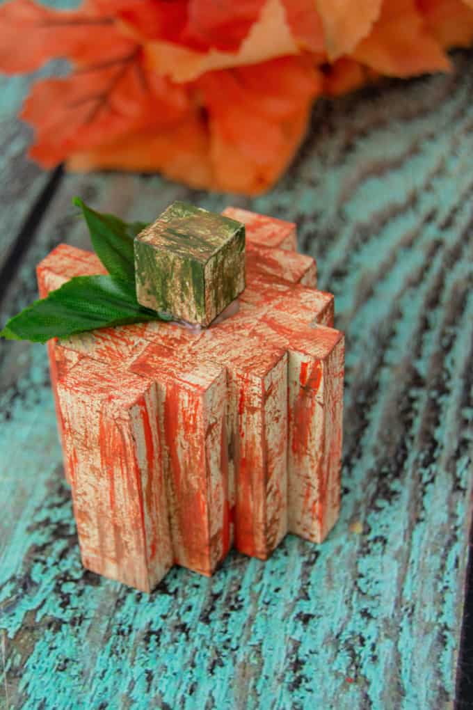 Narrow wood pieces stacked side-by-side to look like pumpkins