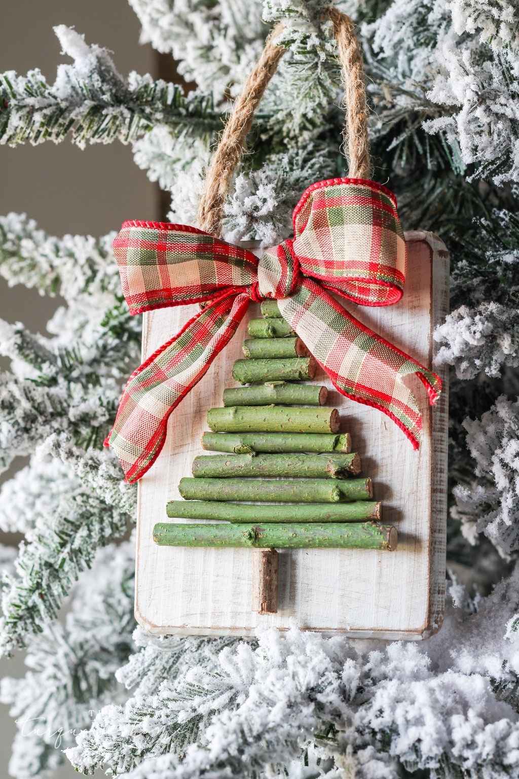 Wood block with twigs in the shape of a Christmas tree