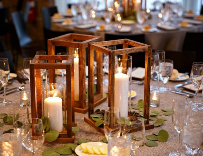 Three wood lanterns on a tablescape