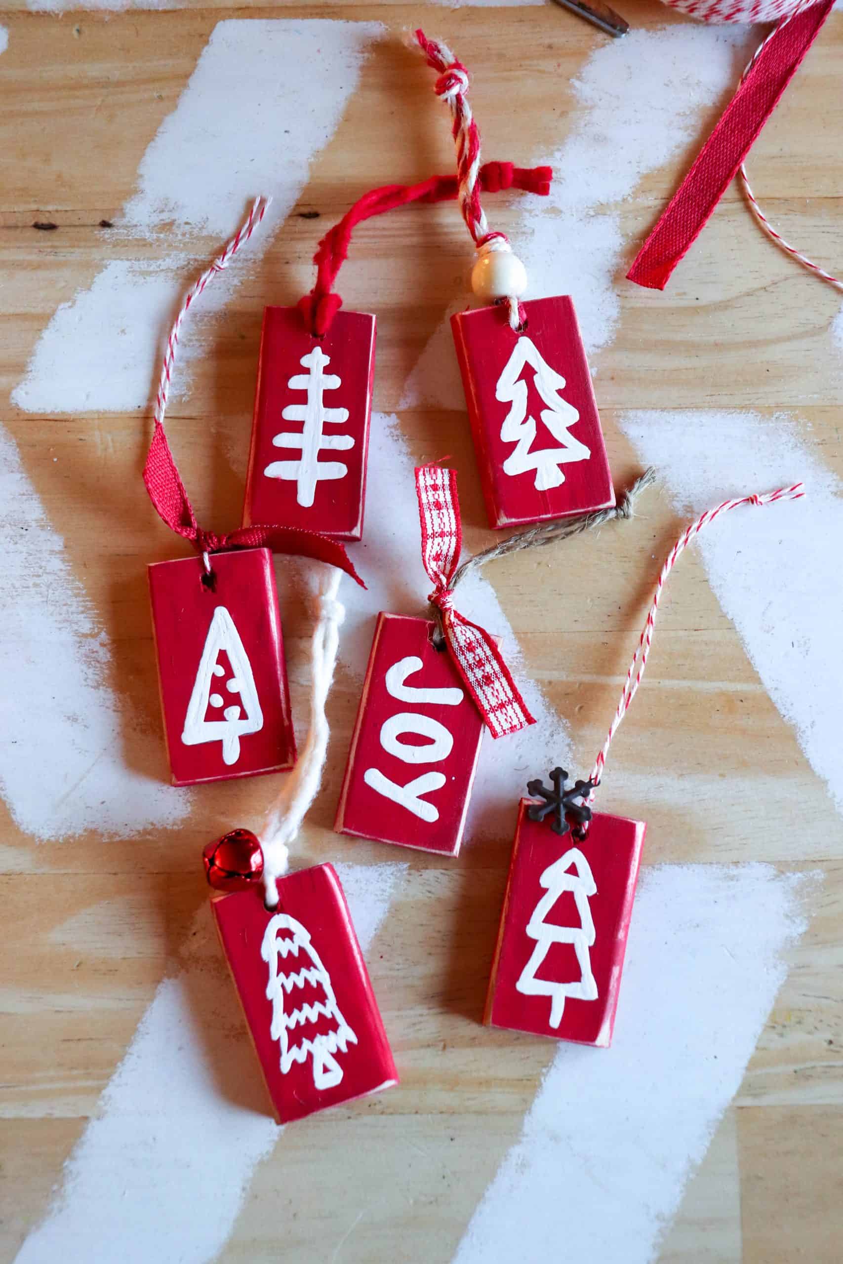 Red blocks with white painted Christmas trees and the word joy