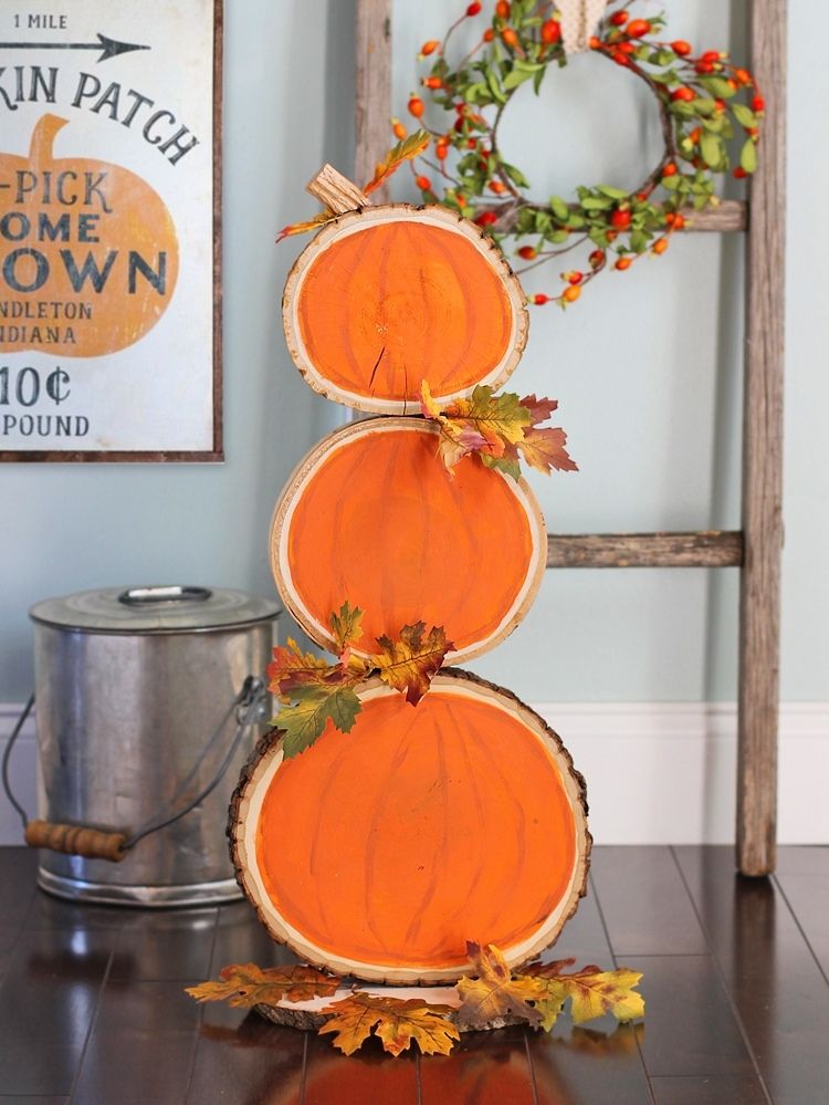 Pumpkin painted wood slices stacked three high
