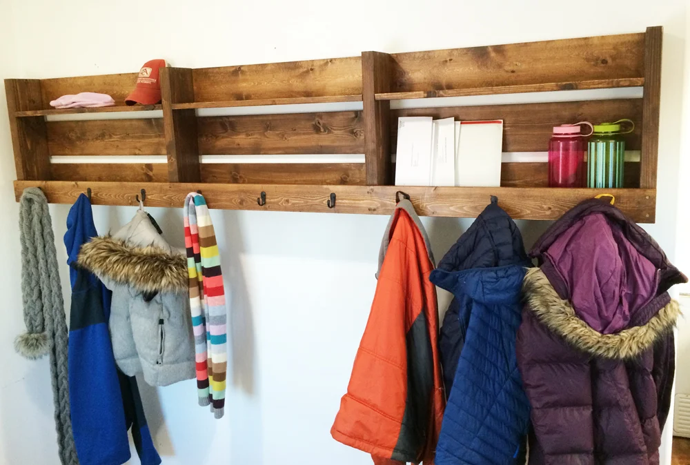 Long coat rack with three sections, shelf above and nine hooks below