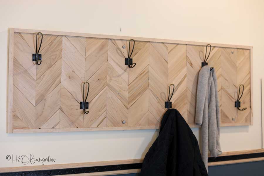 Chevron-style coat rack with six hooks on a wall