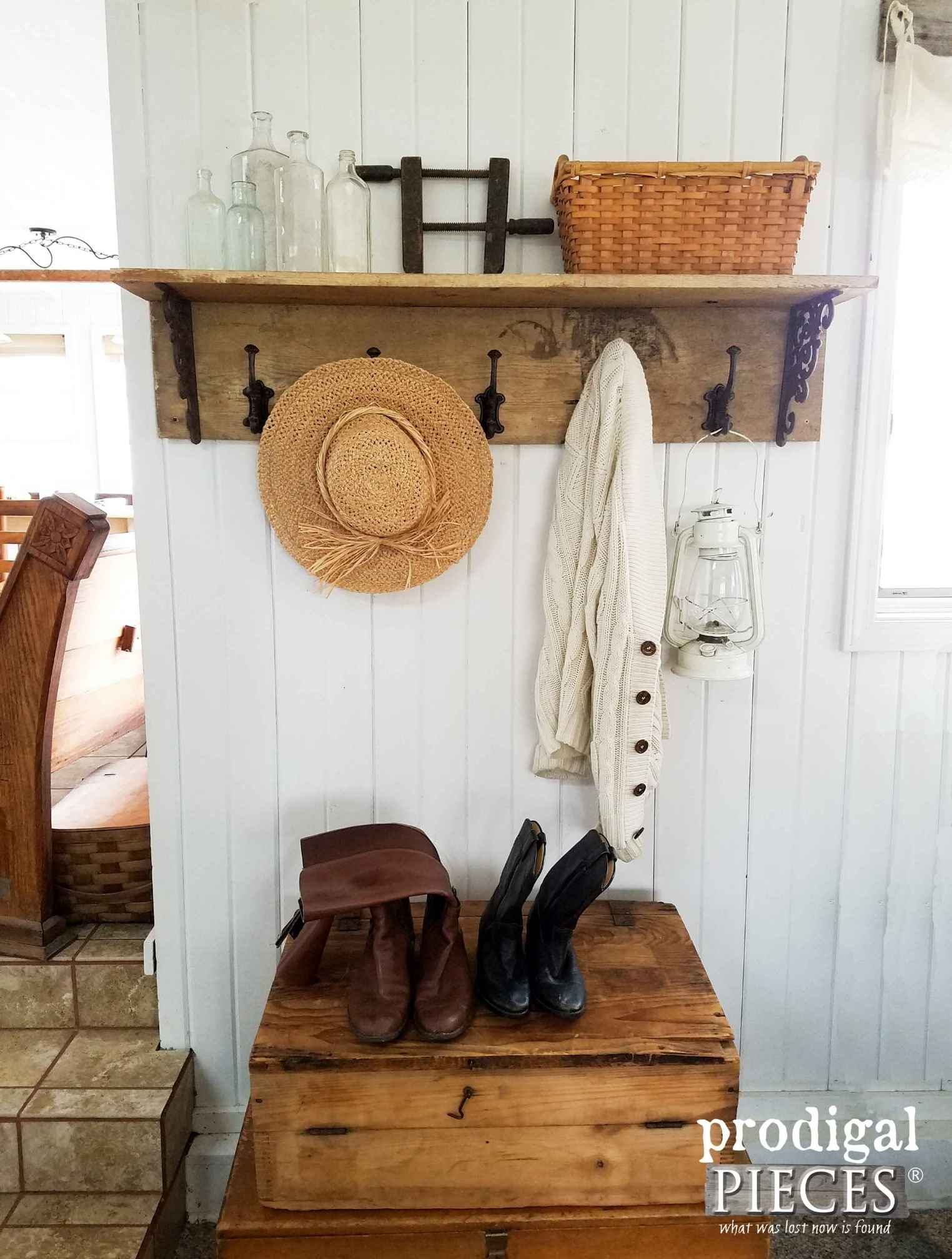 Wood coat rack with large hooks and a hanging hat and jacket