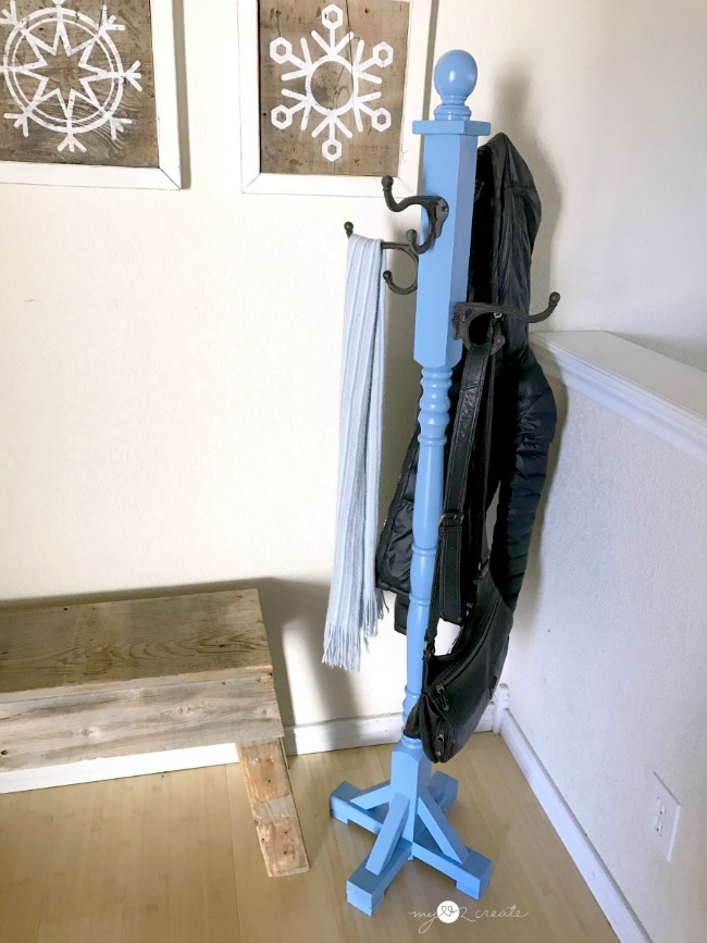 Blue freestanding coat rack with a scarf and coat