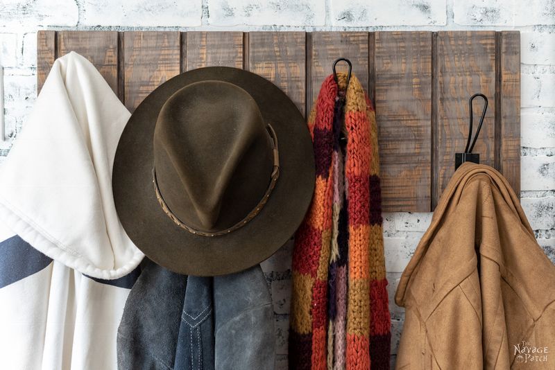 Coat rack with vertical grooves and hooks