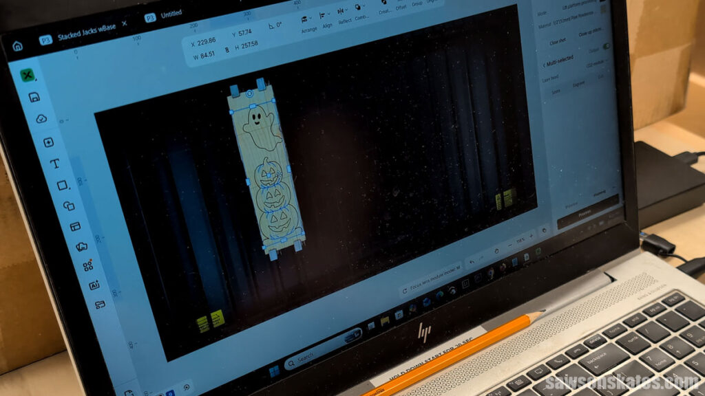 Laptop screen showing the xTool P3's live view and positioning the ghost and pumpkin on the board