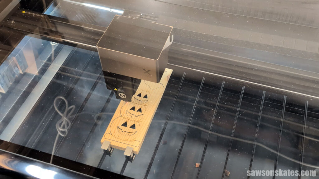 xTool P3 cutting out a ghost and stacked pumpkins from a board