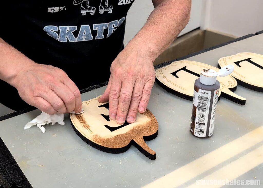 Applying stain to the pumpkin backer