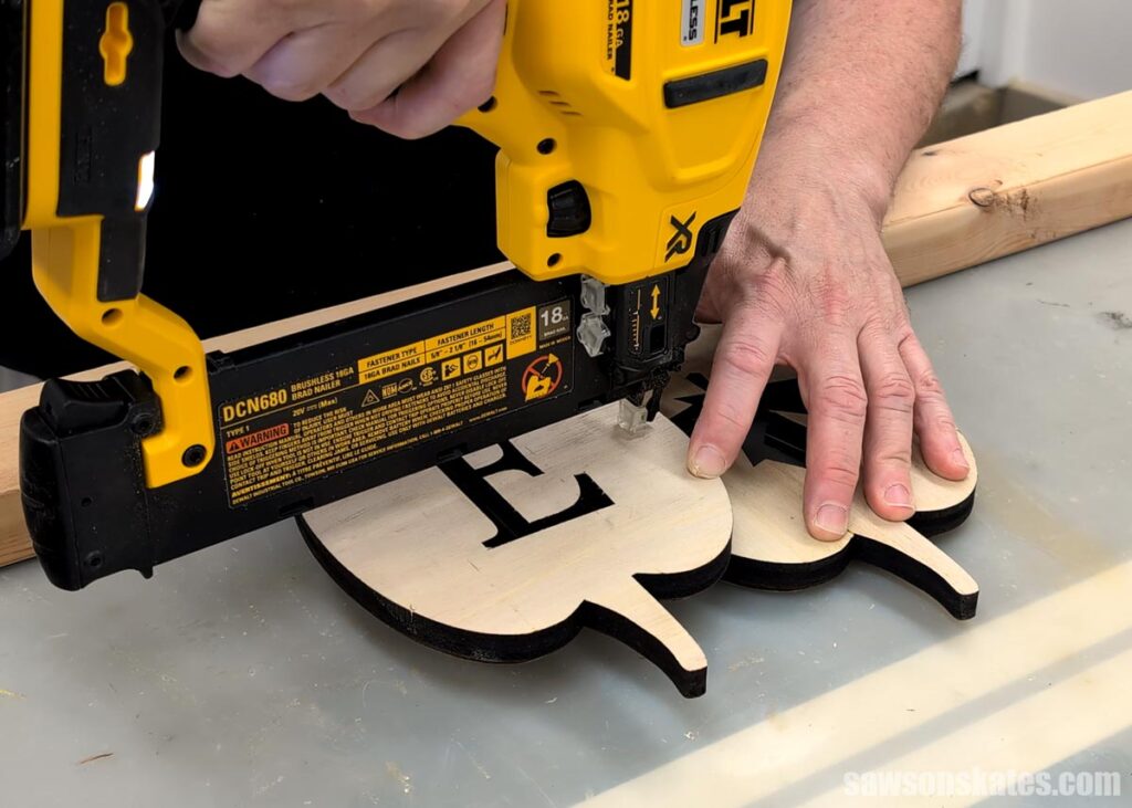 Attaching one pumpkin to another with a brad nailer